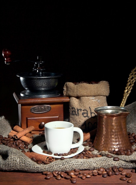 Metal turk and coffee cup on dark background