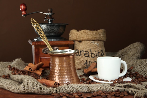 Metal turk and coffee cup on dark background