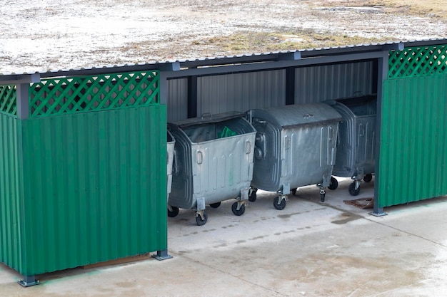 Metal waste containers for separate collection of waste in the\
courtyard of a multistorey residential building