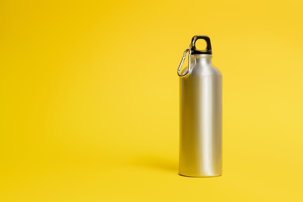 Metal water bottle on yellow background