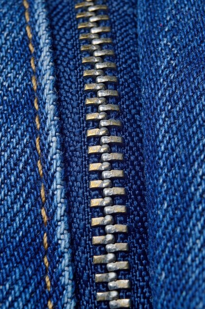 Metal zipper on blue jeans. macro