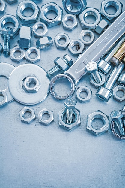 Metallic background with stack of tapped steel tools construction concept