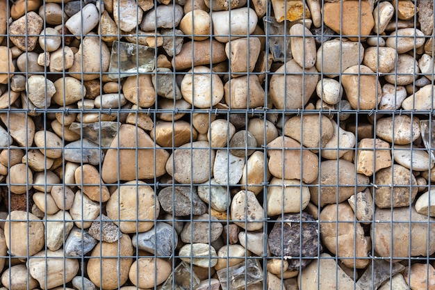 Metallic basket net filled by natural stones as a fence