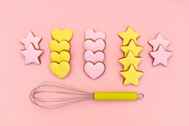 Metallic cookie cutters different shapes and whisk 