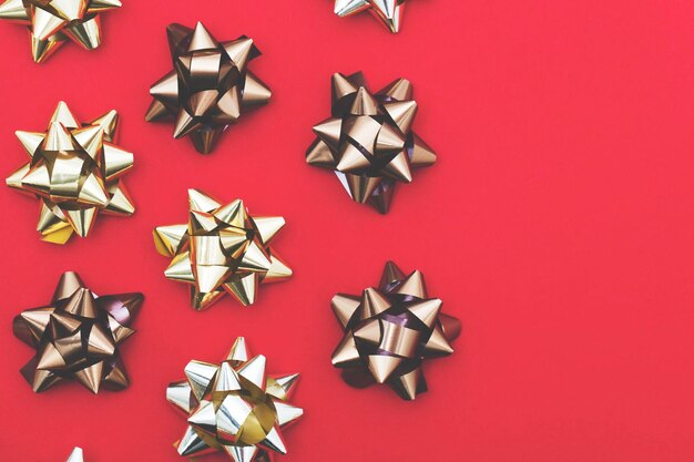 Metallic gift bow on a red background