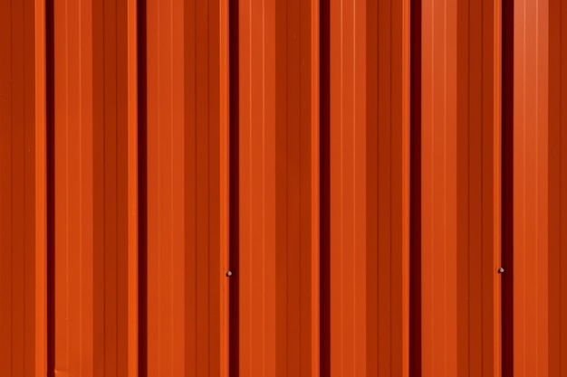 Metallic orange background An empty background for your text for advertising or design Vertical metal panels on the wall of the building