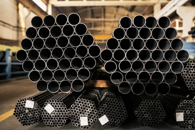 Metallic pipes on warehouse, rows of metal pipes on industrial warehouse. 