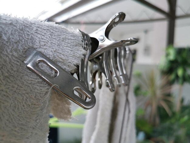 Photo metallic or plastic hangers and clips use to dry clothes outdoor at the open space porch