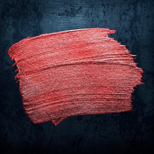 Metallic red oil paint brush stroke texture on a black background