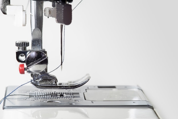 Metallic sewing machine foot. Studio light macro photo