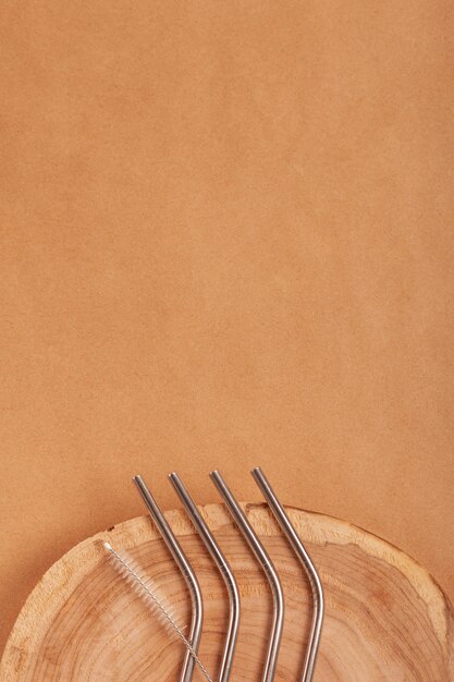 Metallic staws for cocktails on a brown background