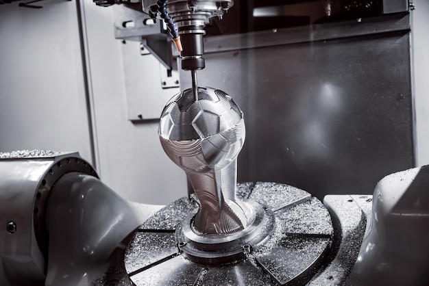 Metalworking CNC milling machine. Cutting metal modern processing technology. Small depth of field. Warning - authentic shooting in challenging conditions. A little bit grain and maybe blurred.