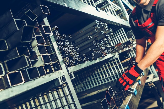 Metalworking warehouse with shelves full of metal profiles and tubes