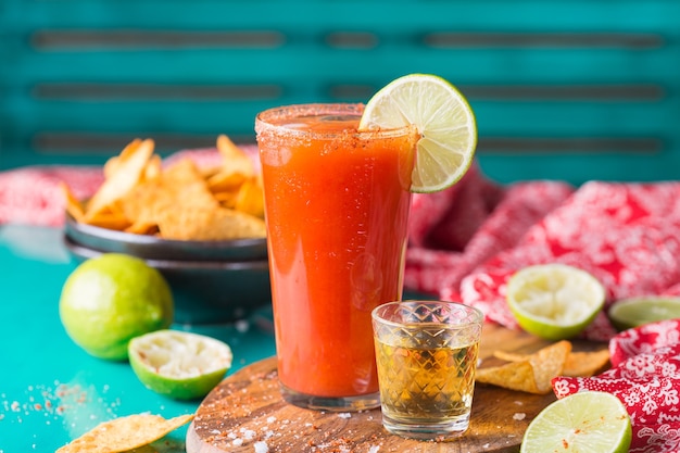 Mexican alcohol cocktail chavela served with tequila shot