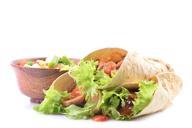 Mexican burrito with chicken and vegetables on a white background