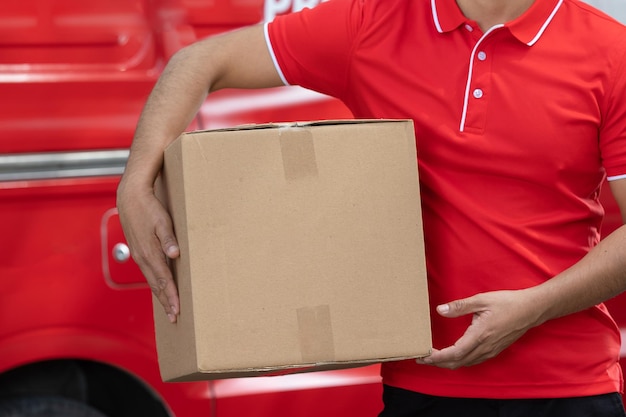 Mexican delivery man holding a big cardboard box