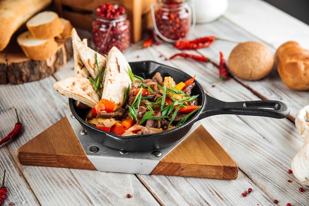 Mexican dish fajitos with beef vegetables and pita