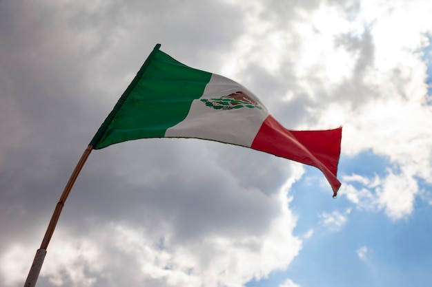 mexican flag flying on a flagpole in a mexican house Mexico independence day concept