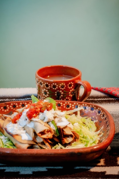 Mexican flautas with lettuce avocado cream sauce and fresh water