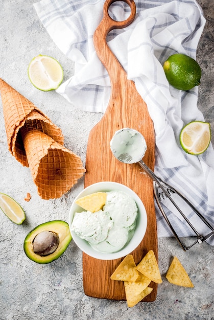 Mexican food, homemade organic lime and avocado ice cream, with ice cream cones, slices of sweet tortilla. On a grey stone table, copyspace