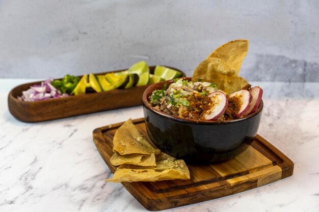 Mexican food meat bowl with meat juice cilantro and onion on the cover mexican wooden plates