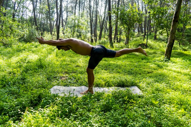 Mexican man doing yoga and stretching in the forest mexico