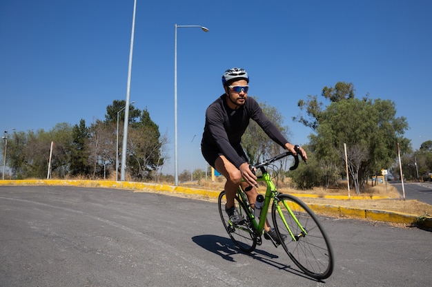 Mexican man riding bicycle on city