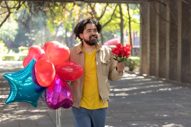 Mexican man walking with balloons and bouquet of flowers on Valentine39s