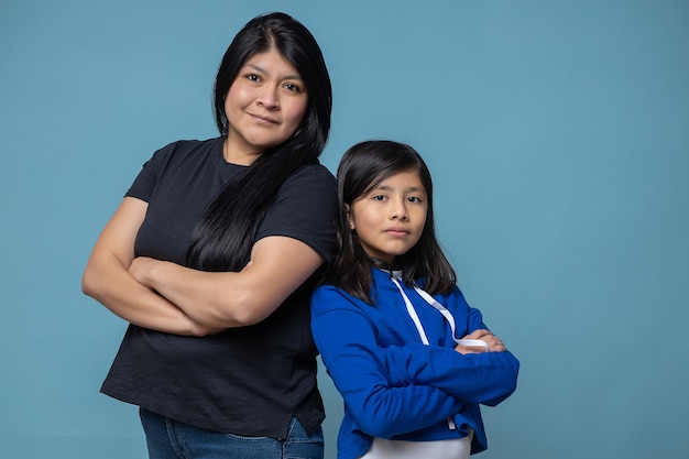 Mexican mother and daughter arms crossed, girl power