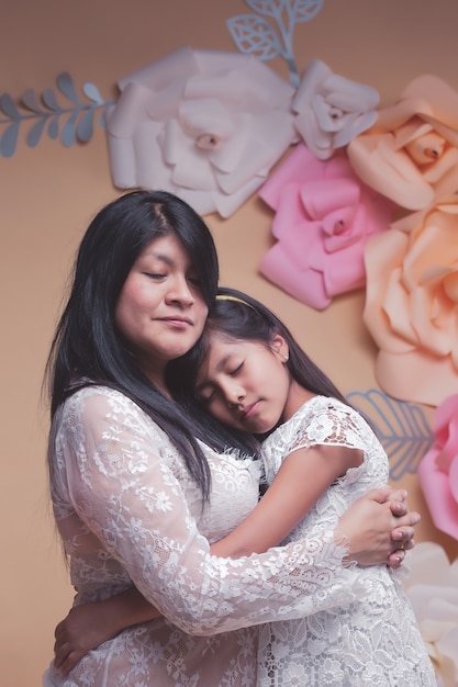 Mexican mother and daughter hug 