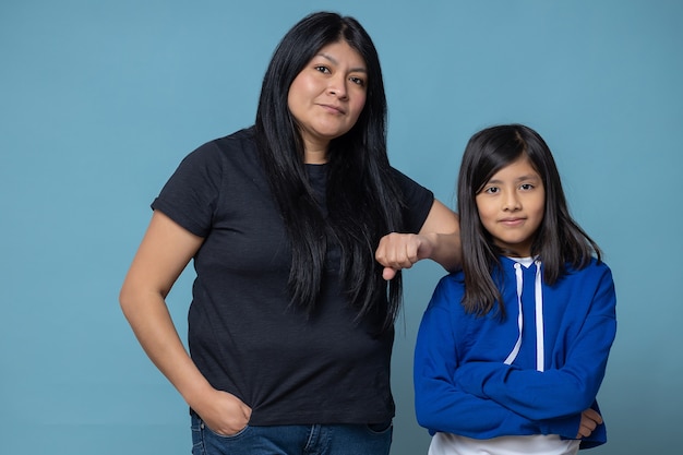 Mexican mother and daughter isolated, girl power