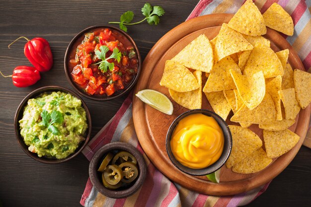 Mexican nachos tortilla chips with guacamole, salsa and cheese dip