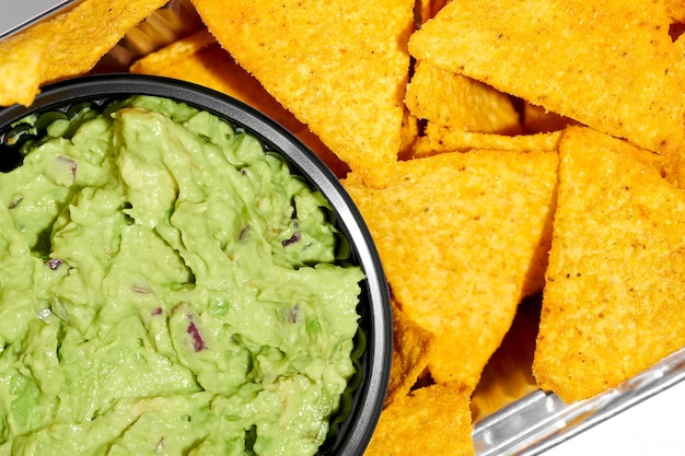 Mexican nachos with avocado guacamole on a white background Hard Light