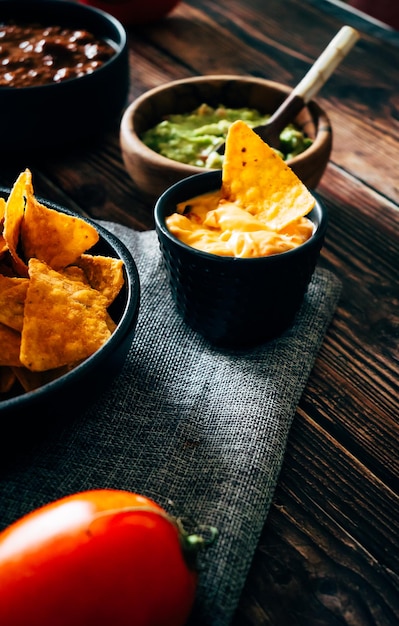 Mexican nachos with guacamole, cheddar cheese and chili. Typical mexican dish