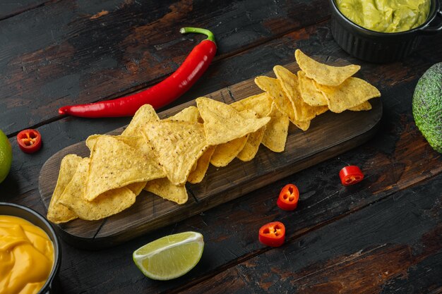 Mexican nachos with sauce set, on old wooden table