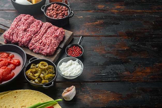 Mexican quesadilla and ingredients, on old dark  wooden table background  with copy space for text