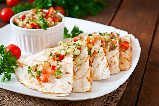 Mexican Quesadilla wrap with chicken, corn and sweet pepper and salsa