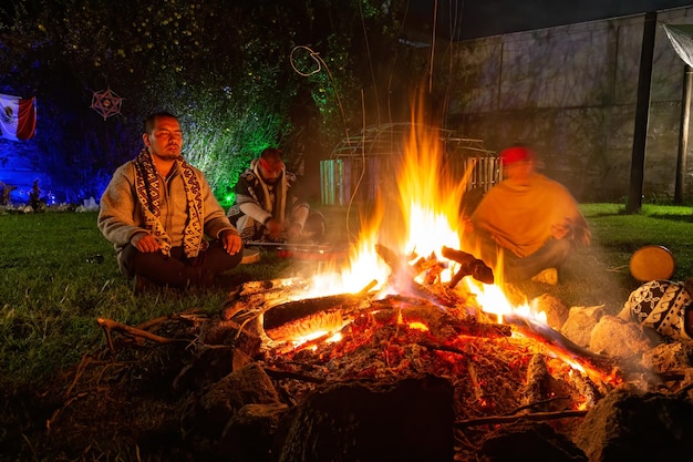 Mexican shamans meditating in front of a campfire