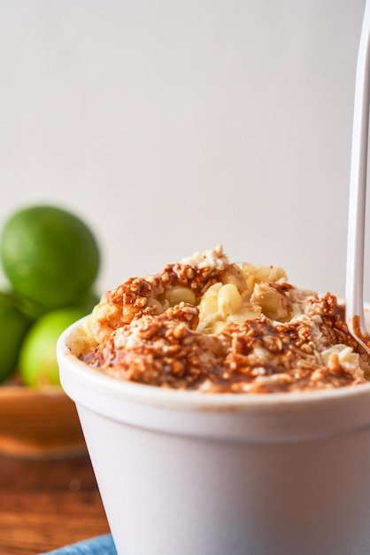 Mexican snack prepared esquite corn in a cup with chili