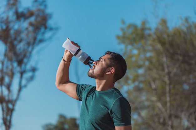 Mexican sports man drinking water