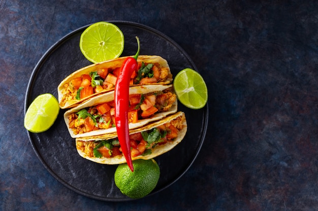 Mexican taco and limes on a dark background