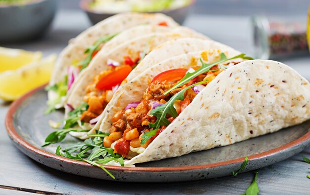 Mexican tacos with beef, beans in tomato sauce and salsa