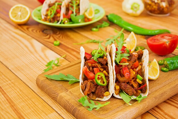 Mexican tacos with beef in tomato sauce