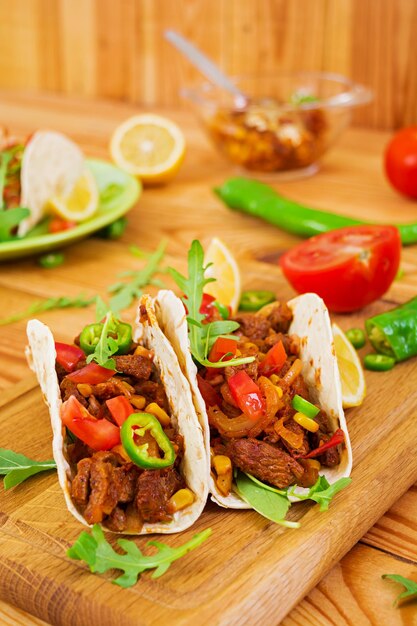 Mexican tacos with beef in tomato sauce