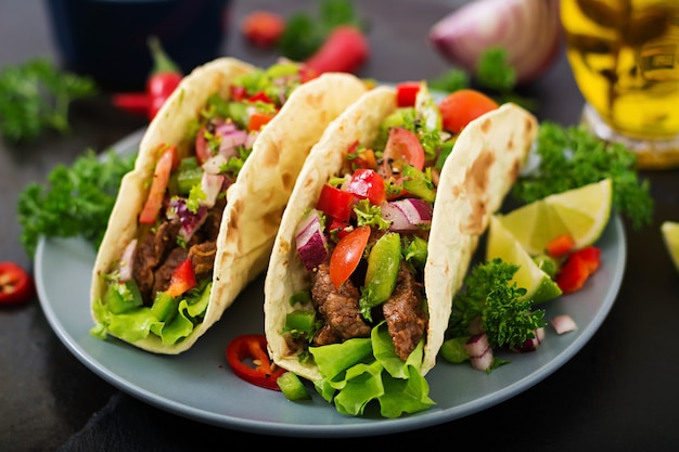 Mexican tacos with beef in tomato sauce 