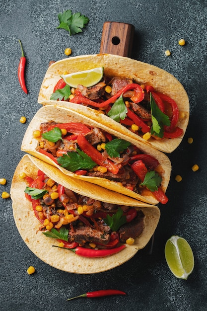 Mexican tacos with beef, vegetables and salsa.