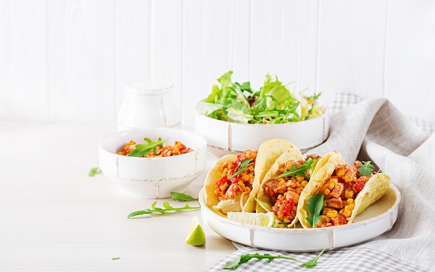 Mexican tacos with chicken meat, corn and tomato sauce. Latin American cuisine. Taco, tortilla, wrap.