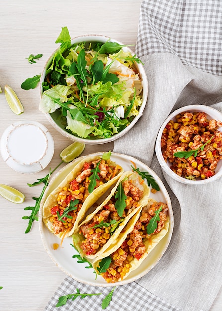 Mexican tacos with chicken meat, corn and tomato sauce. Taco, tortilla, wrap. 