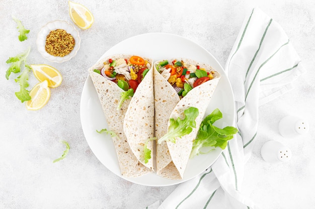 Mexican tacos with chicken meat and vegetables Top view