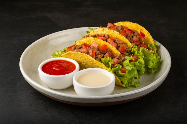 Mexican tacos with lettuce beef and tomatoes